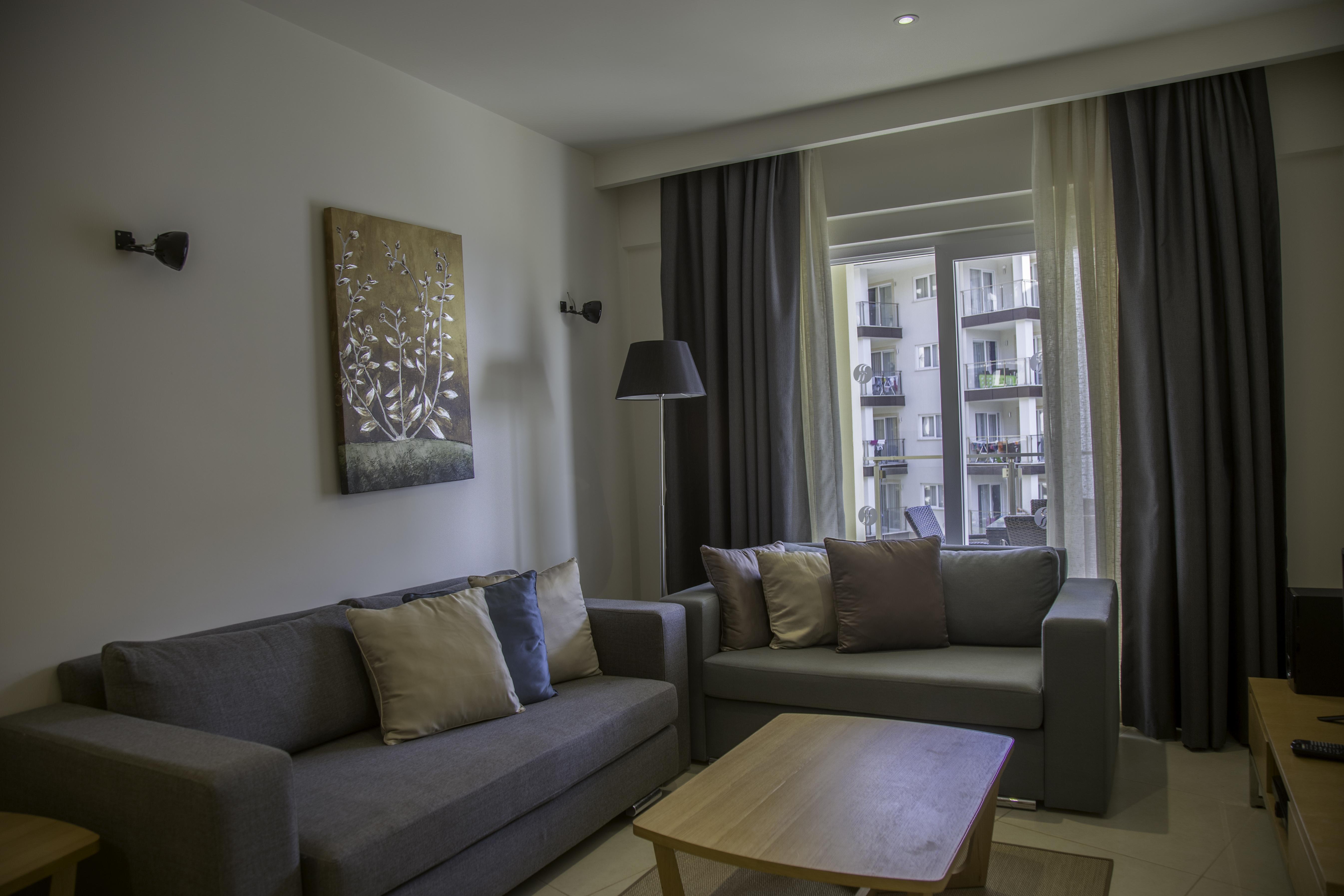 Ramada Resort Kusadasi & Golf Exterior photo A living room in a serviced apartment in Bucharest, Romania