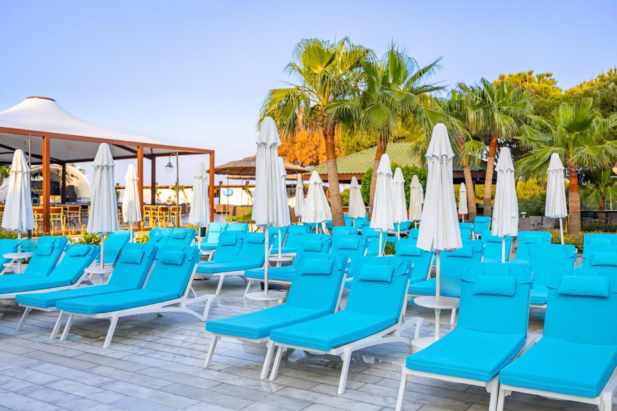 Ramada Resort Kusadasi & Golf Exterior photo Sunloungers at a resort in Turkey
