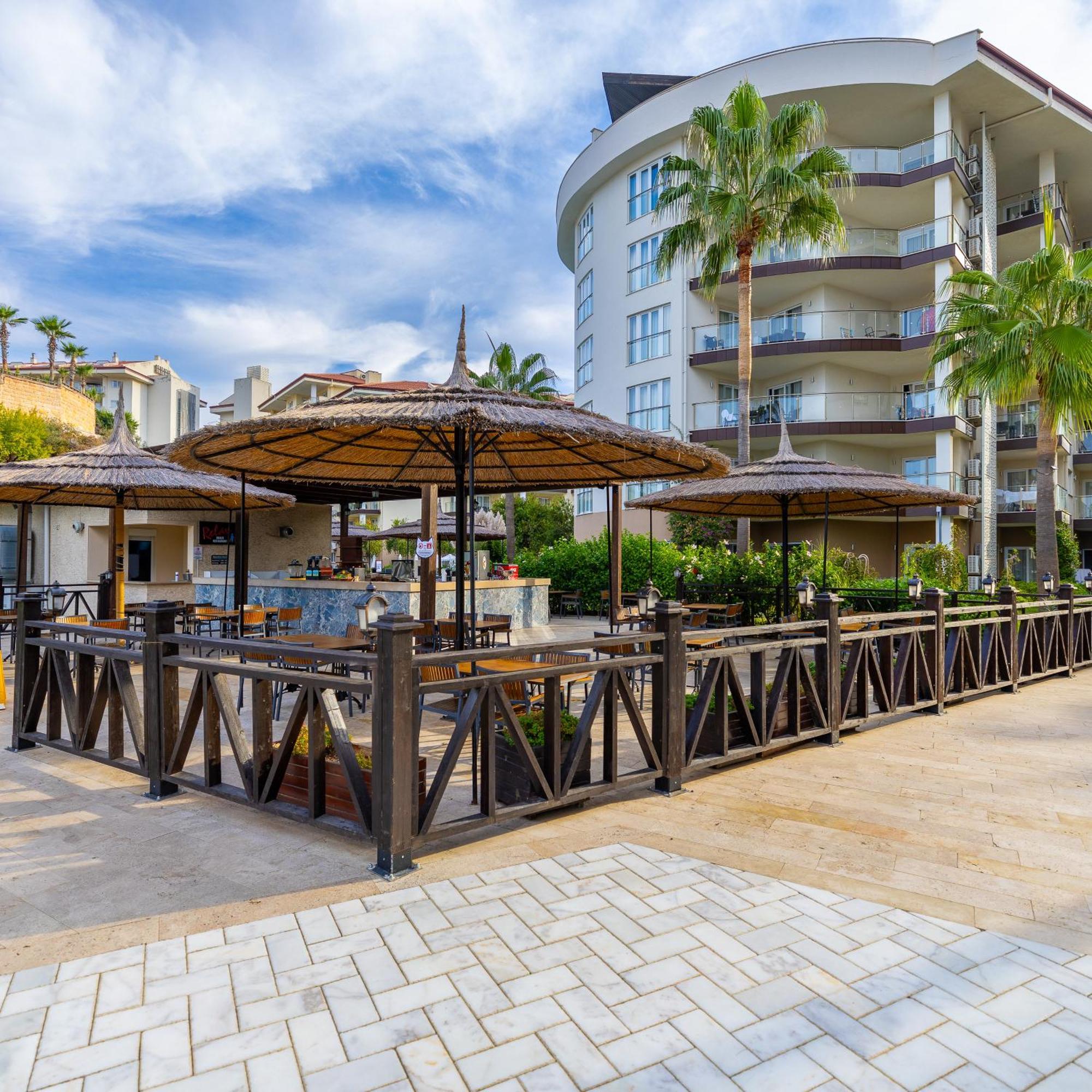 Ramada Resort Kusadasi & Golf Exterior photo A poolside bar in Turkey
